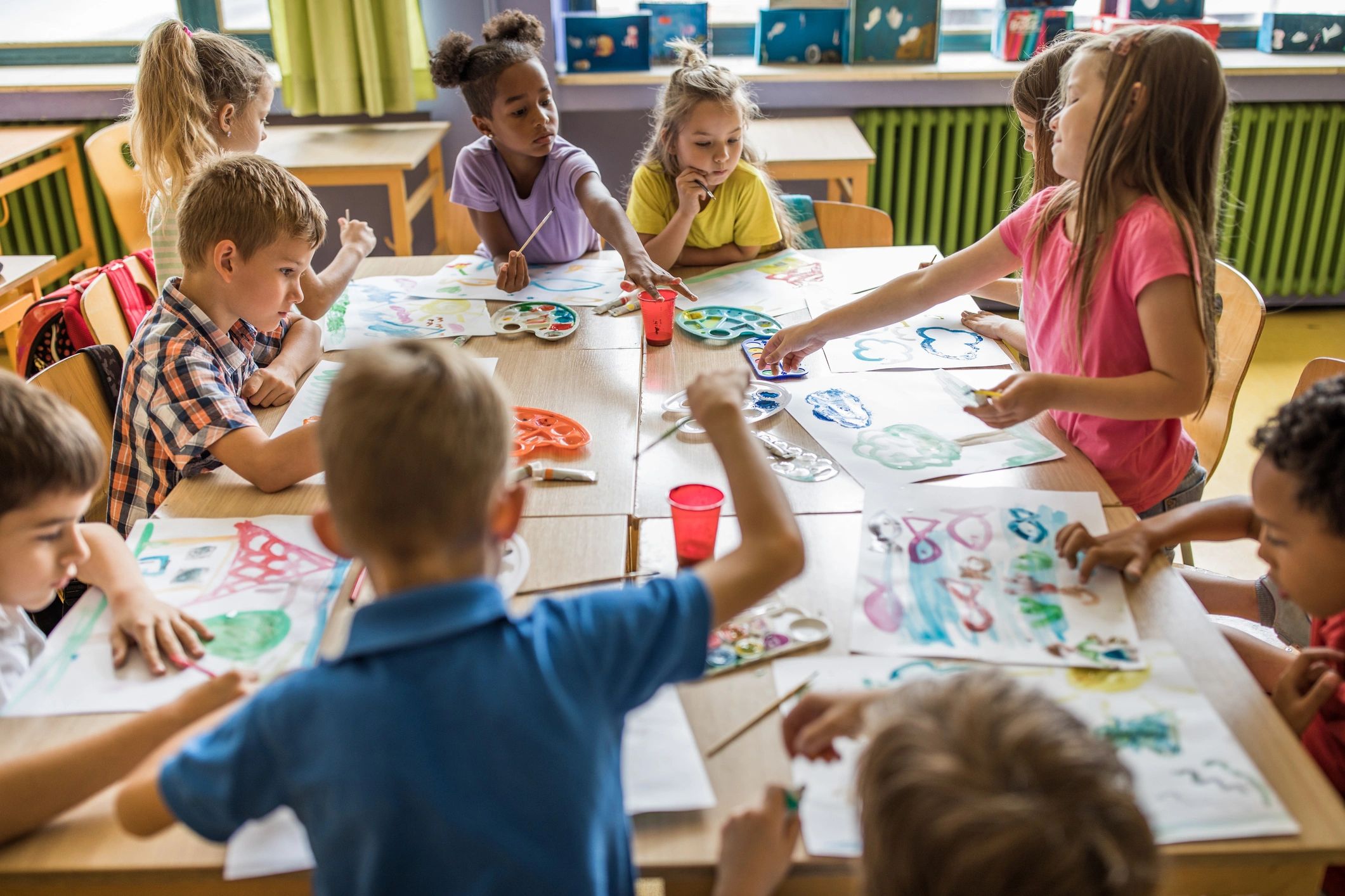 Children painting during an art activity in a classroom
