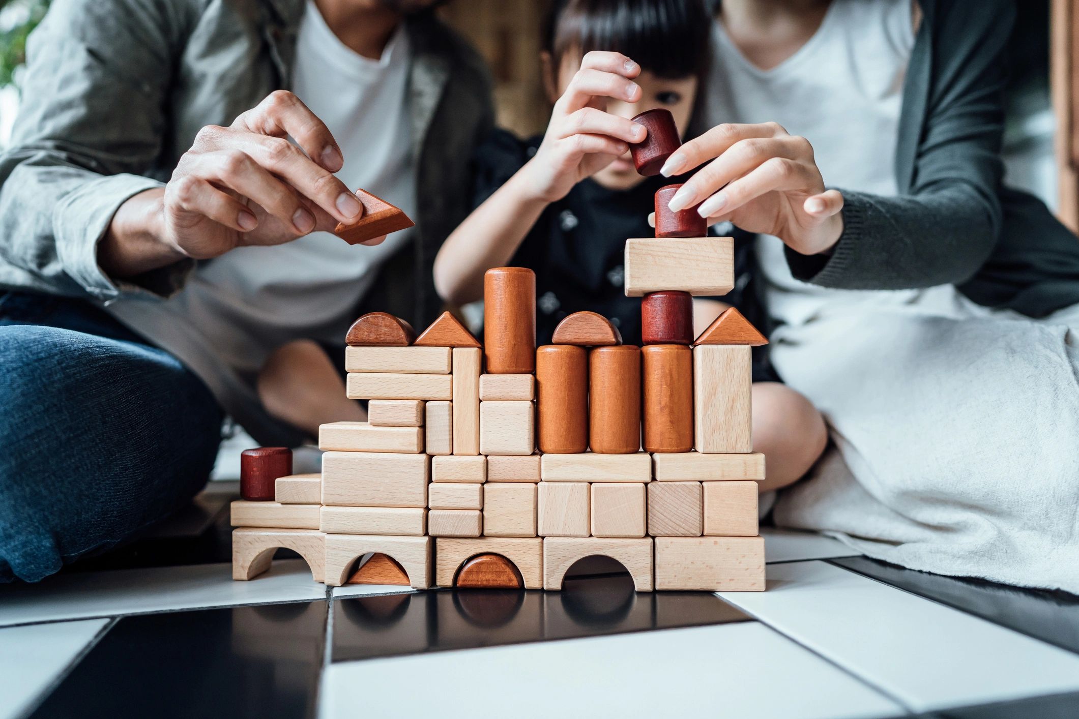 Child building with wooden blocks during play