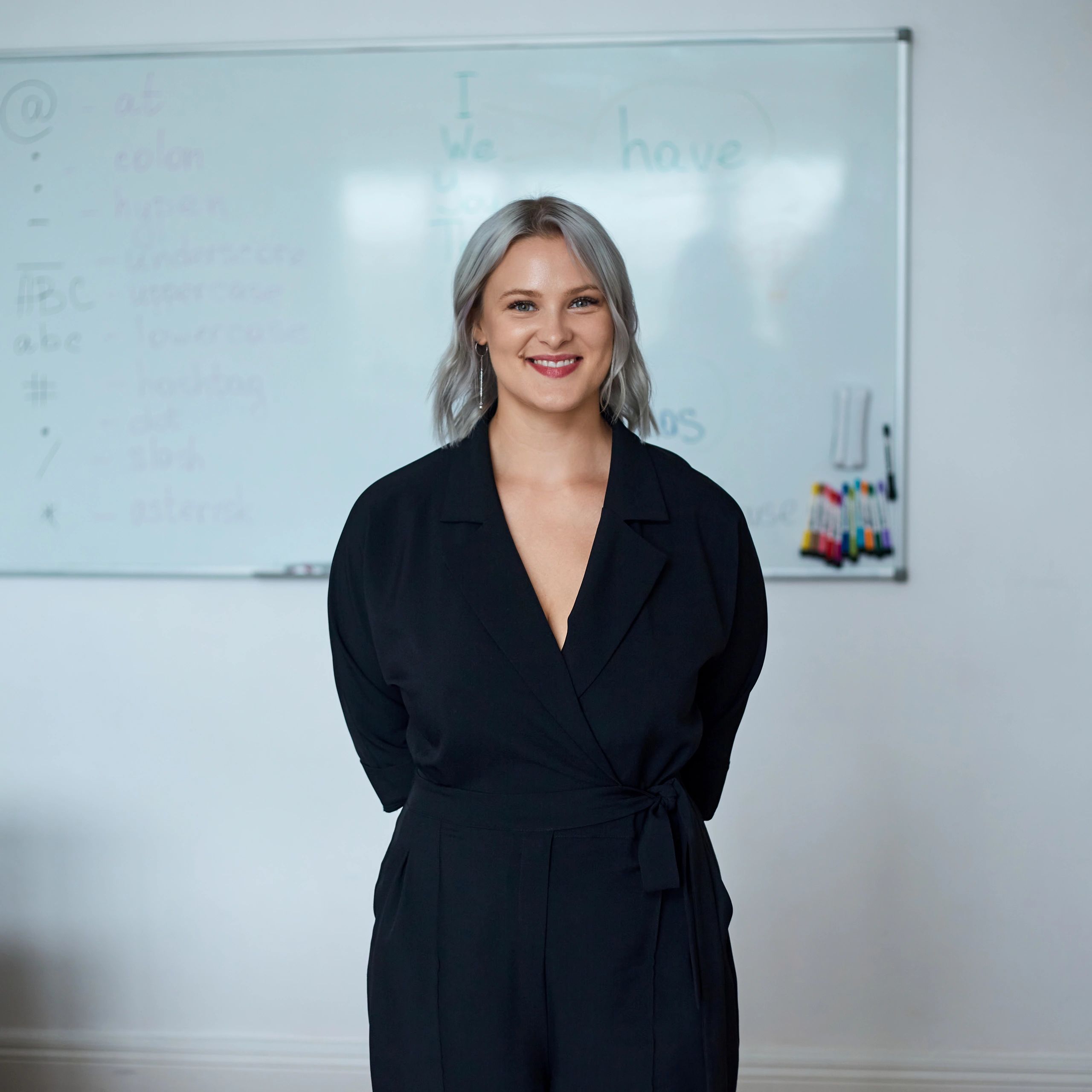 Portrait of a teacher smiling in a classroom setting