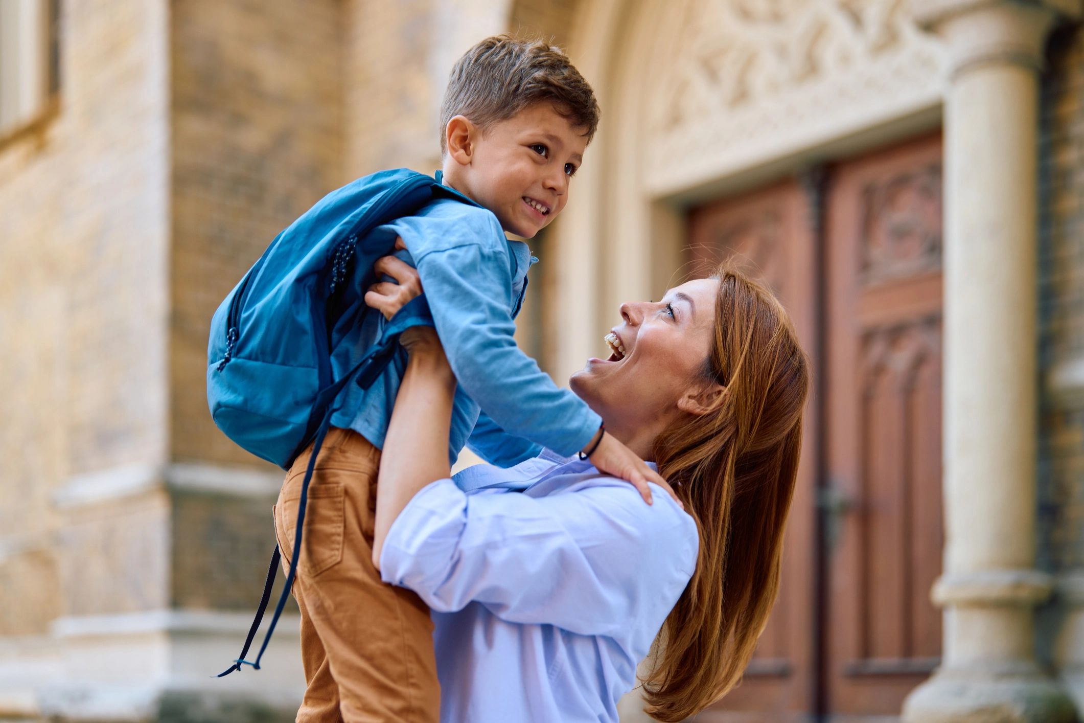 Parent and child sharing a happy moment at drop-off