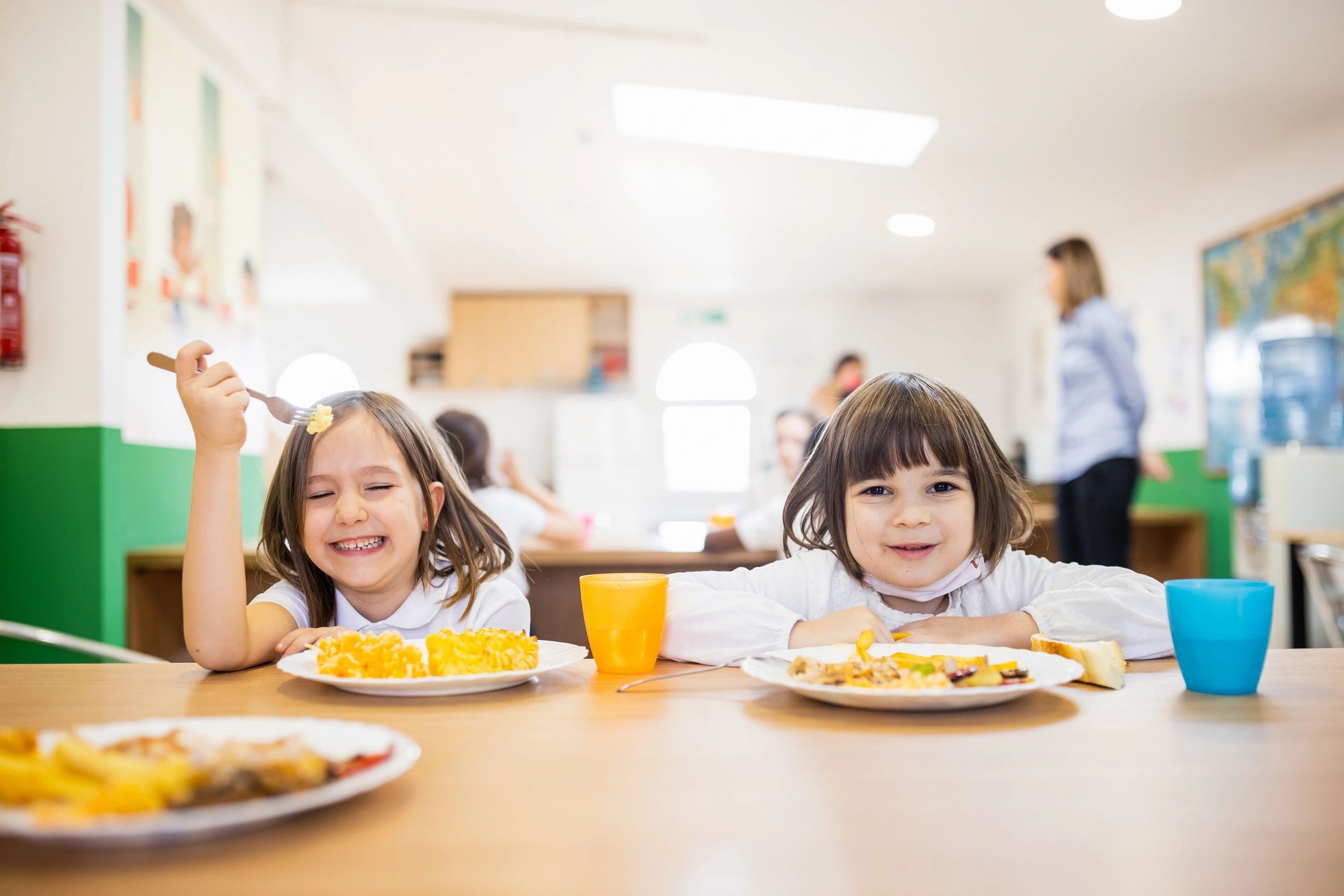 Smiling child enjoying lunch at school