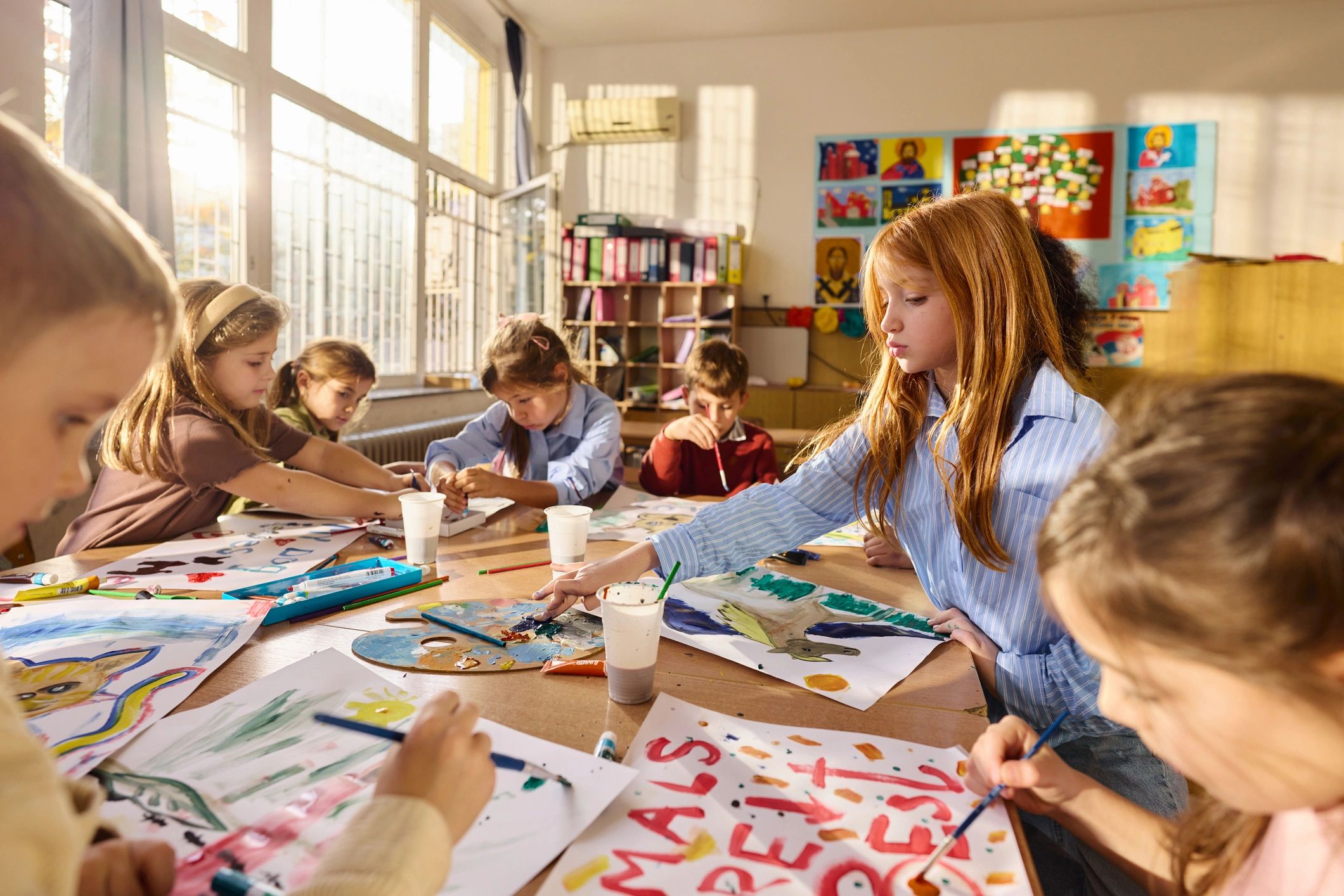 Children painting together during an art activity